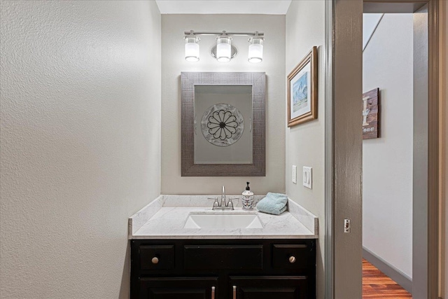 bathroom featuring wood-type flooring and vanity