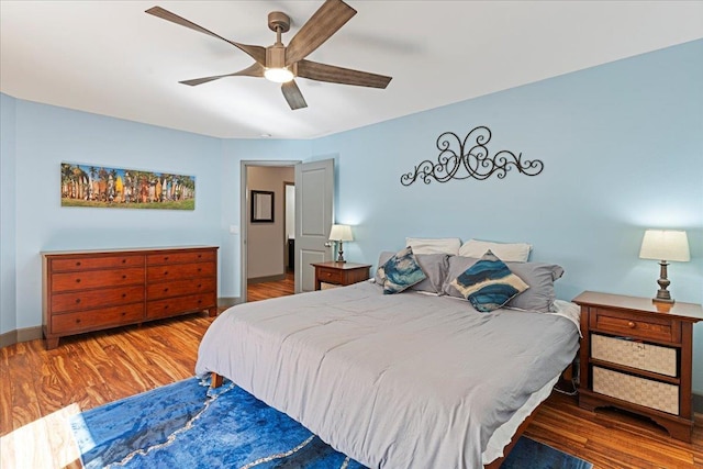 bedroom with hardwood / wood-style flooring and ceiling fan