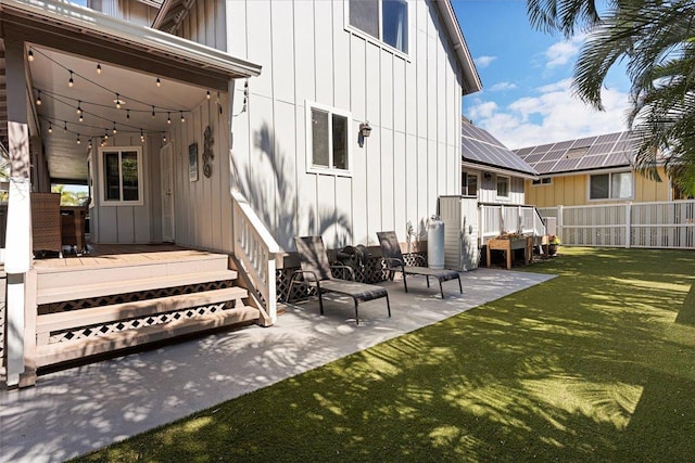 rear view of property with a lawn, a patio, and a deck