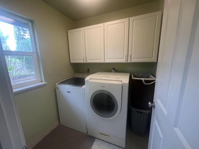 washroom featuring cabinets and independent washer and dryer