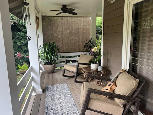 wooden terrace with ceiling fan and covered porch