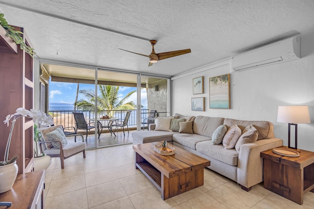 760 S Kihei Rd Unit 419, Kihei, HI 96753 - living room featuring a wall mounted air conditioner, floor to ceiling windows, a ceiling fan, light tile patterned flooring, and a textured ceiling