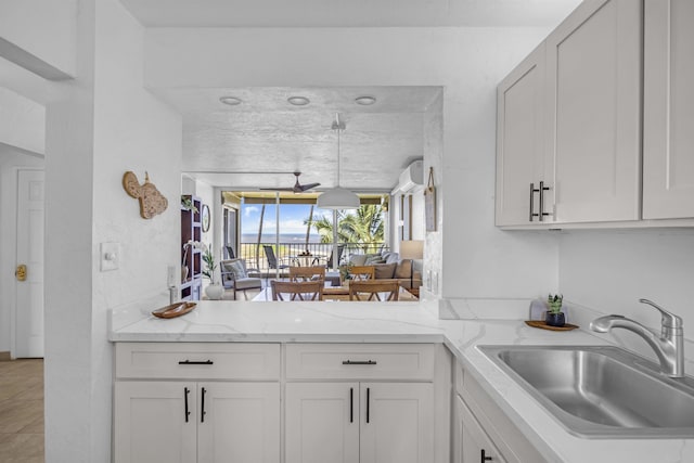 760 S Kihei Rd Unit 419, Kihei, HI 96753 - kitchen featuring a sink, white cabinetry, and light stone counters