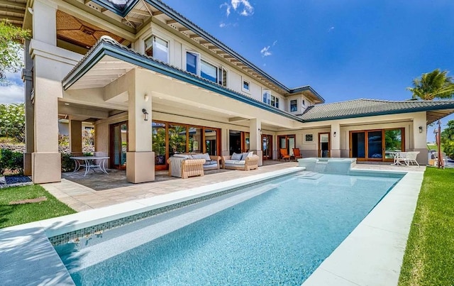 rear view of house featuring a patio area and outdoor lounge area