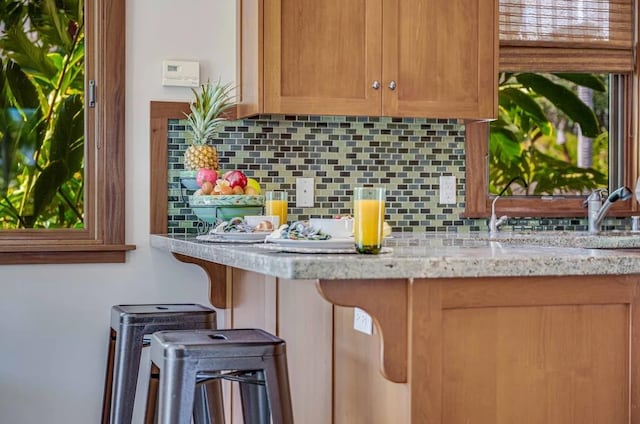 kitchen featuring light stone counters and decorative backsplash