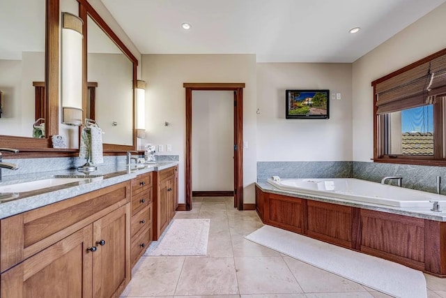 bathroom featuring tile patterned flooring, a bathtub, and dual vanity