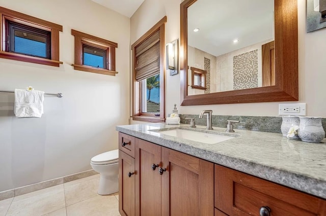 bathroom with tile patterned flooring, toilet, and vanity