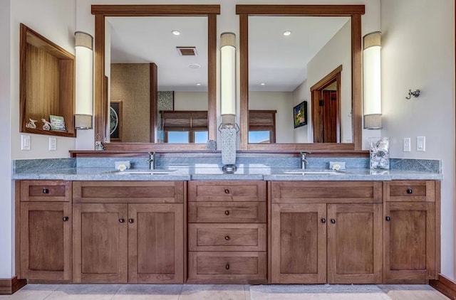 bathroom featuring dual bowl vanity and tile patterned flooring