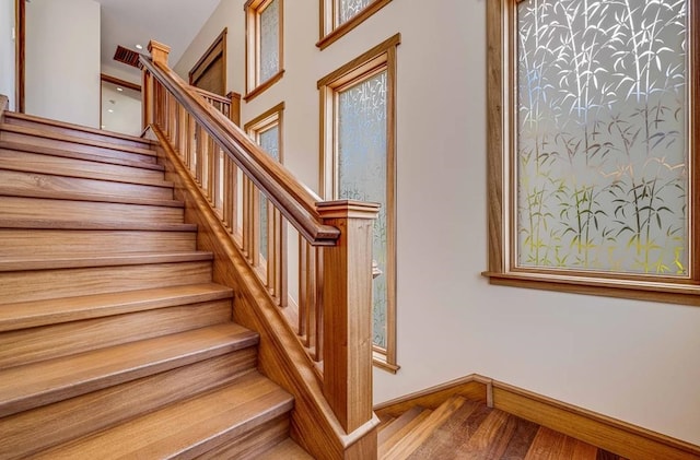 staircase featuring wood-type flooring