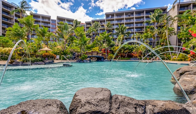 view of pool with pool water feature