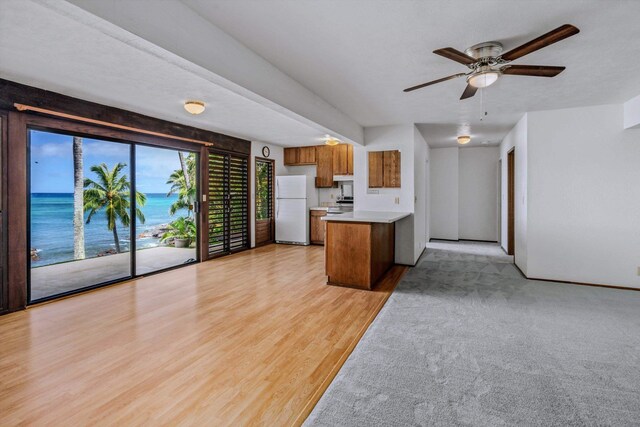29 Hale Malia Pl, Lahaina, HI 96761 - kitchen featuring freestanding refrigerator, brown cabinetry, a peninsula, light wood finished floors, and light countertops
