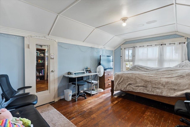 bedroom with lofted ceiling and wood-type flooring