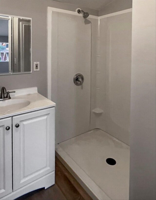 bathroom with a stall shower and vanity