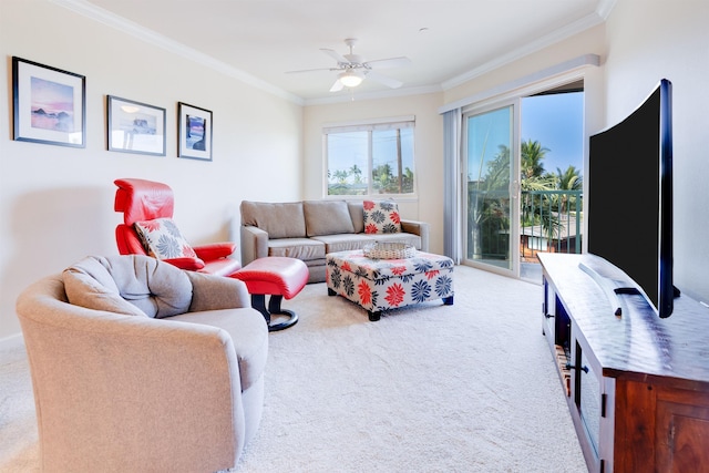 living room featuring carpet, ornamental molding, and a ceiling fan