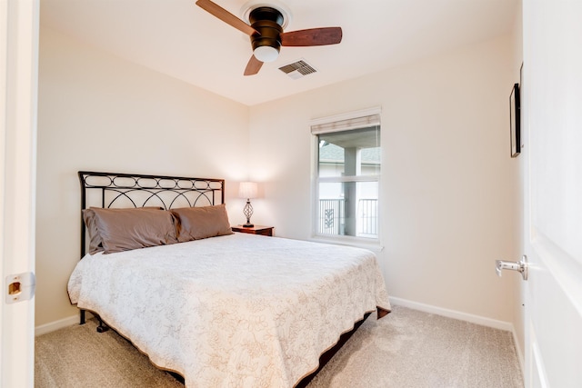 carpeted bedroom with visible vents, ceiling fan, and baseboards