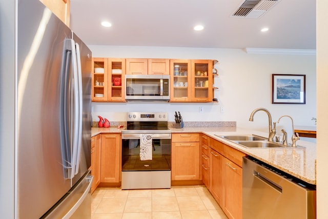 kitchen with crown molding, light tile patterned floors, stainless steel appliances, visible vents, and a sink