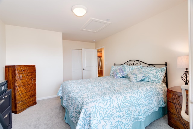 bedroom with light carpet, freestanding refrigerator, attic access, and baseboards