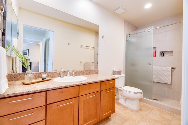 bathroom featuring a stall shower, visible vents, vanity, and toilet