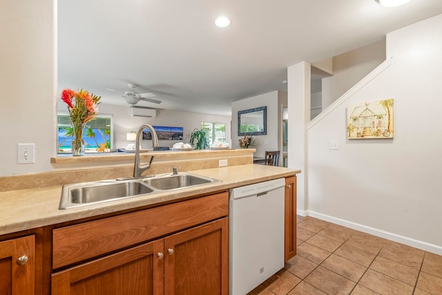 kitchen with sink, ceiling fan, dishwasher, light tile patterned flooring, and an AC wall unit