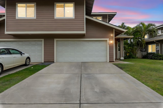 view of front of house featuring a garage and a yard