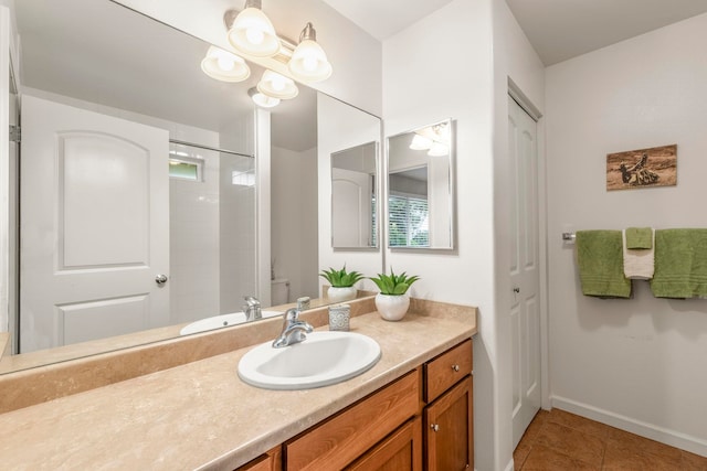 bathroom with vanity, toilet, and tile patterned flooring