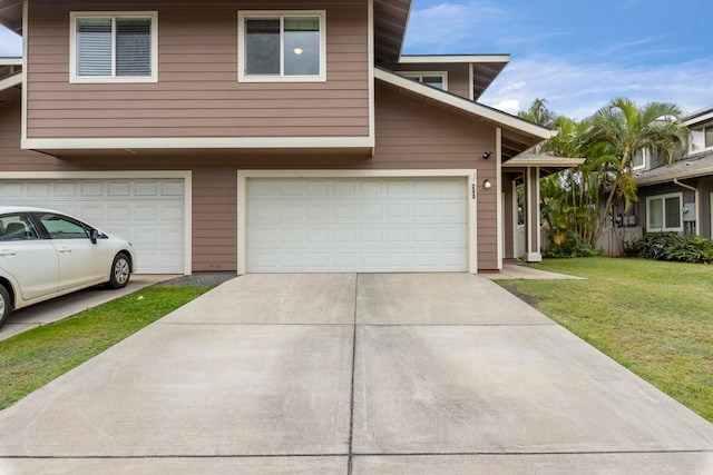 view of front of house featuring a garage and a front lawn