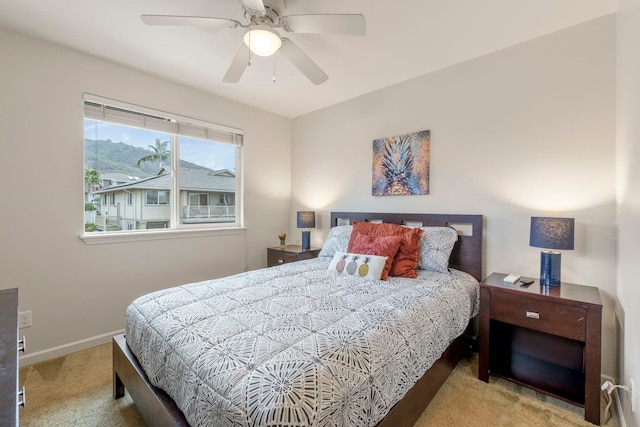 bedroom with light carpet and ceiling fan