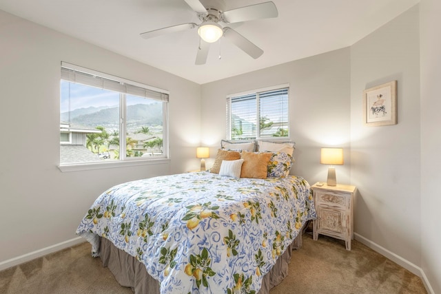 bedroom featuring a mountain view, carpet, and ceiling fan