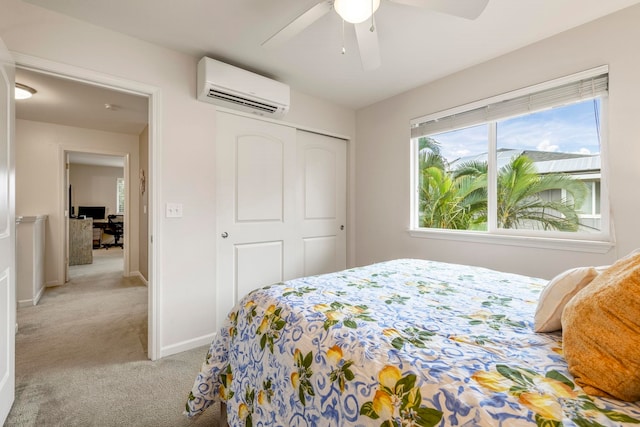 bedroom featuring light colored carpet, a wall unit AC, a closet, and ceiling fan