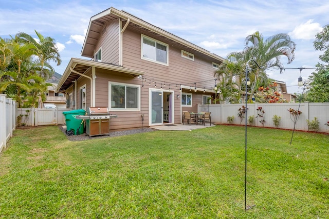 back of house with a yard and a patio area