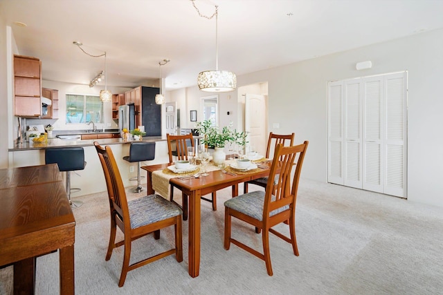 carpeted dining room with sink