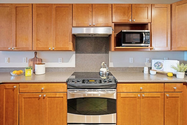 kitchen with appliances with stainless steel finishes and tasteful backsplash