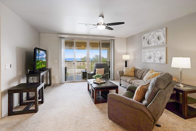 living room with ceiling fan and light colored carpet