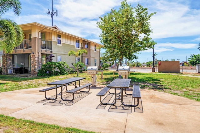 view of community featuring a yard and a patio area