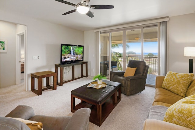 carpeted living room featuring ceiling fan