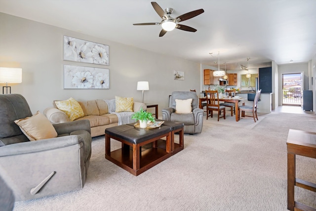 living room with light colored carpet and ceiling fan