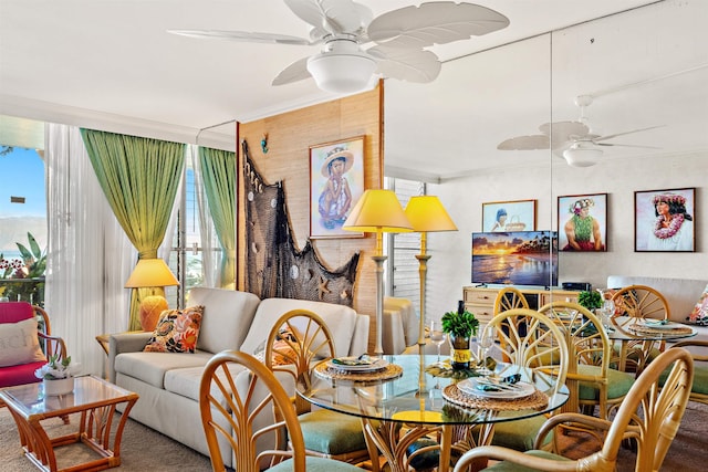 carpeted dining space featuring ornamental molding