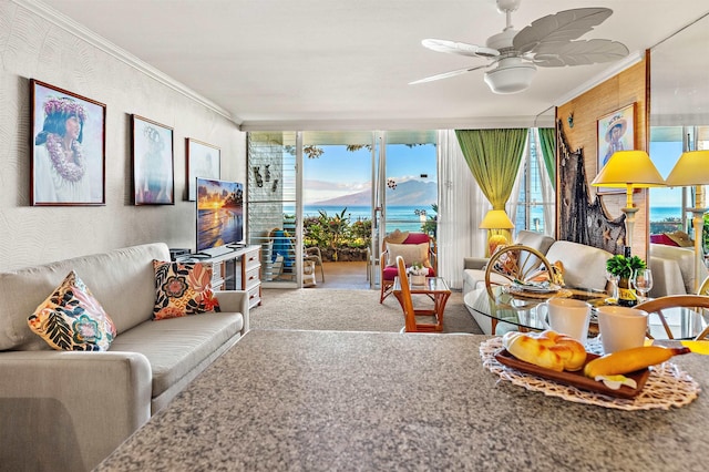 living room featuring carpet flooring, ceiling fan, and crown molding