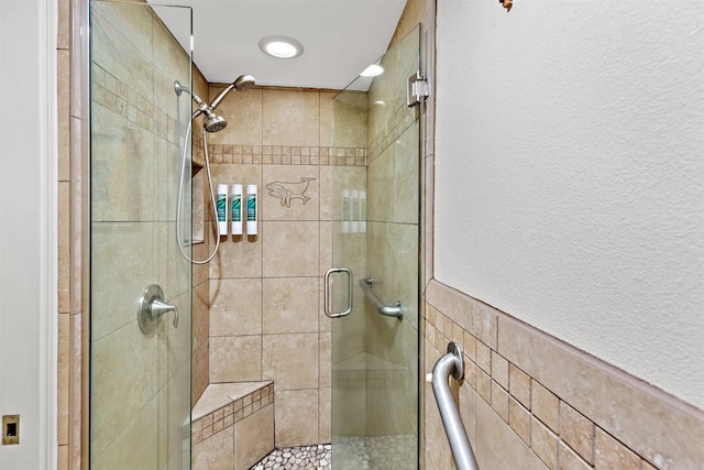 bathroom with walk in shower and tile walls