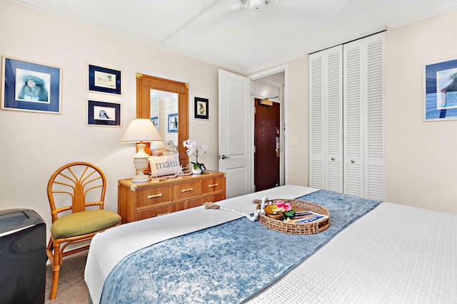 carpeted bedroom with ceiling fan and a closet