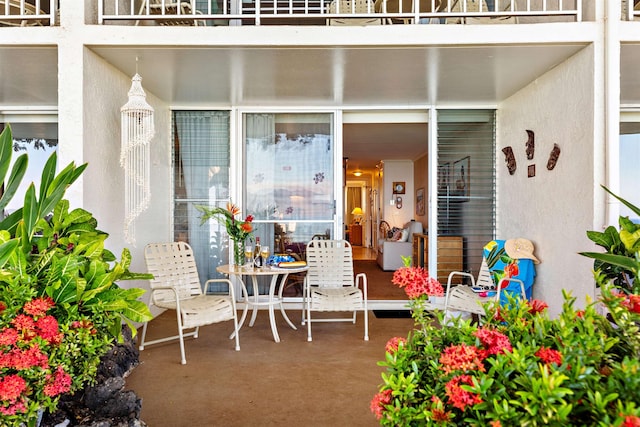 entrance to property with a balcony and a patio