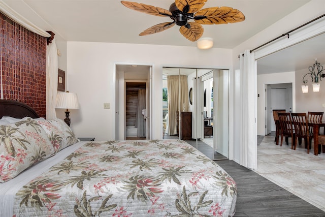 bedroom with ceiling fan, a closet, and hardwood / wood-style flooring