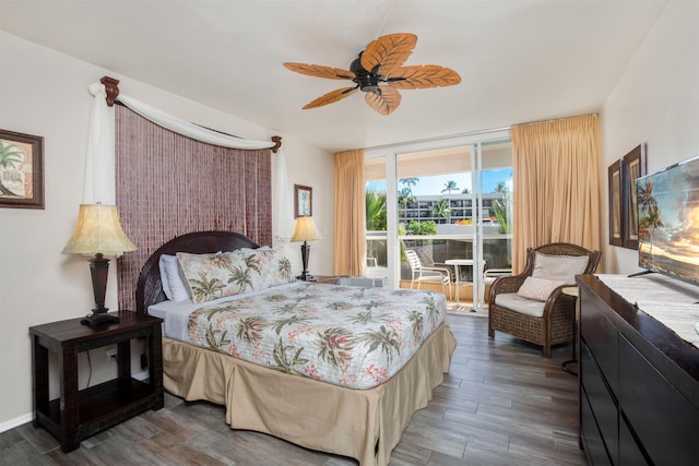 bedroom with ceiling fan, dark hardwood / wood-style floors, and a wall of windows