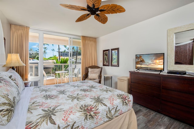 bedroom featuring ceiling fan, expansive windows, and dark hardwood / wood-style flooring