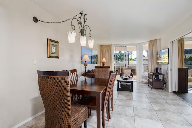 dining space with light tile patterned floors and a chandelier