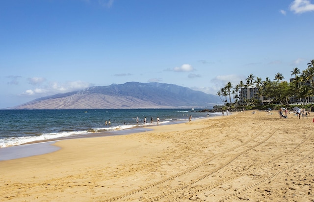 mountain view featuring a beach view and a water view