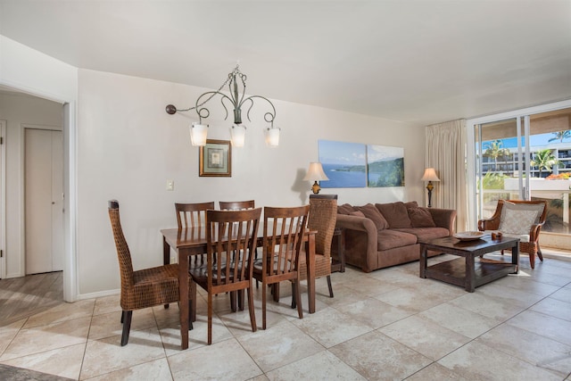 dining space with light tile patterned floors and a chandelier