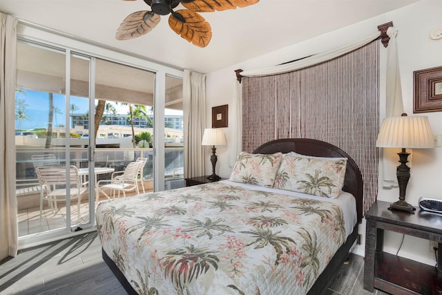 bedroom with ceiling fan, dark wood-type flooring, and access to outside