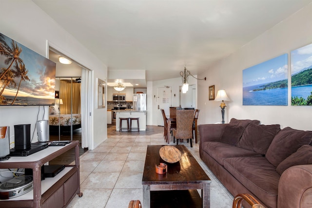 living room featuring light tile patterned floors and an inviting chandelier