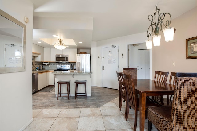 dining space featuring light tile patterned floors